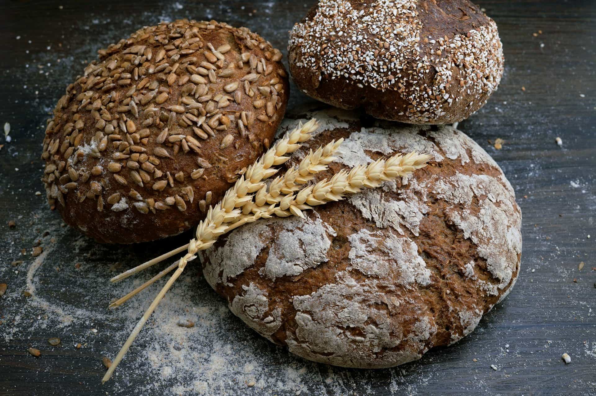 Freshly baked whole-grain bread loaves with wheat ears