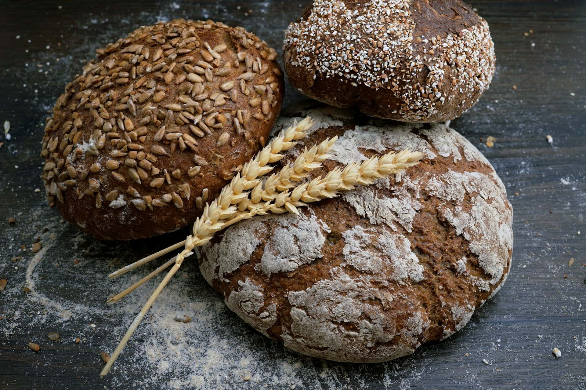 Freshly baked whole-grain bread loaves with wheat ears