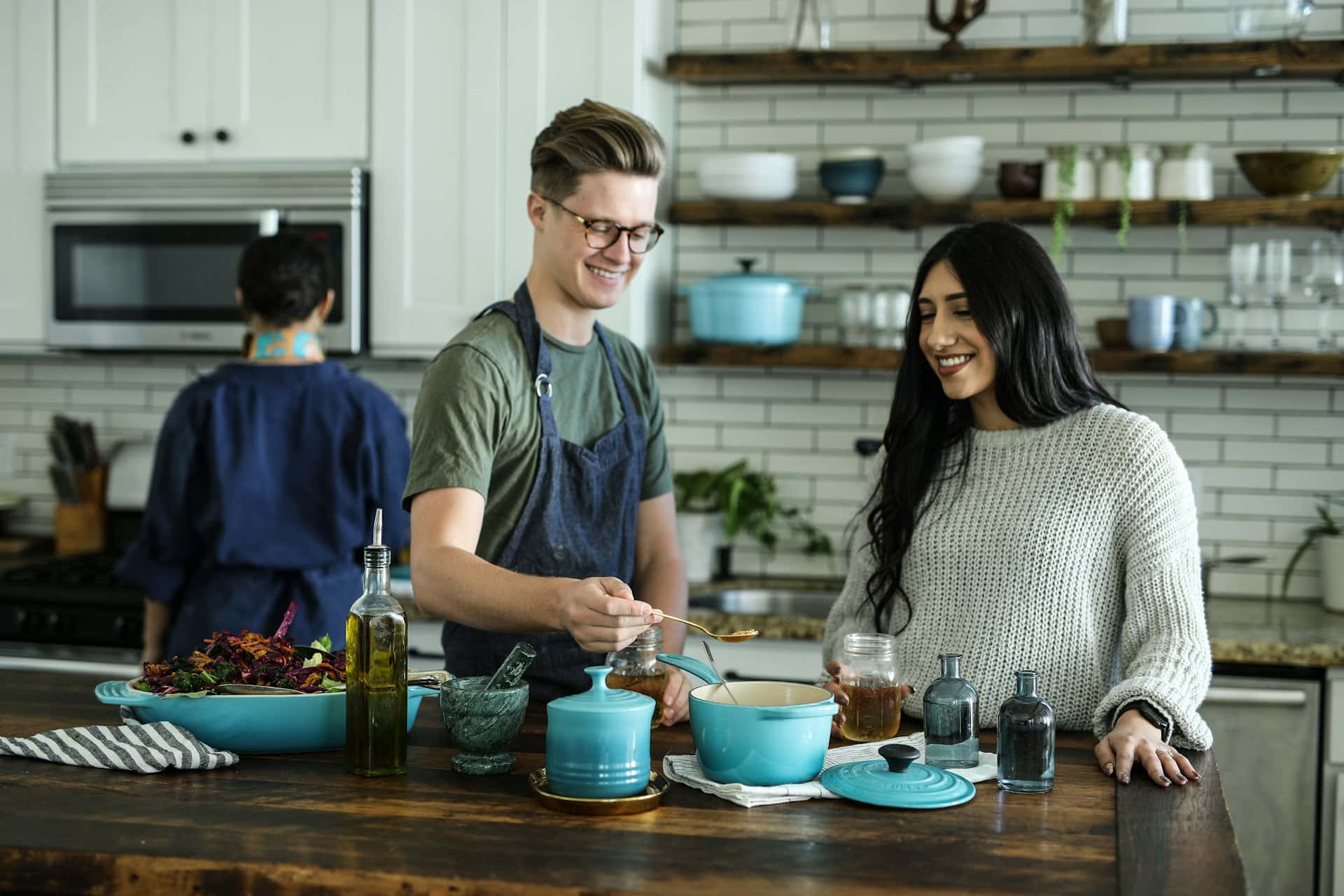 Food handlers preparing meals in a clean commercial-style kitchen