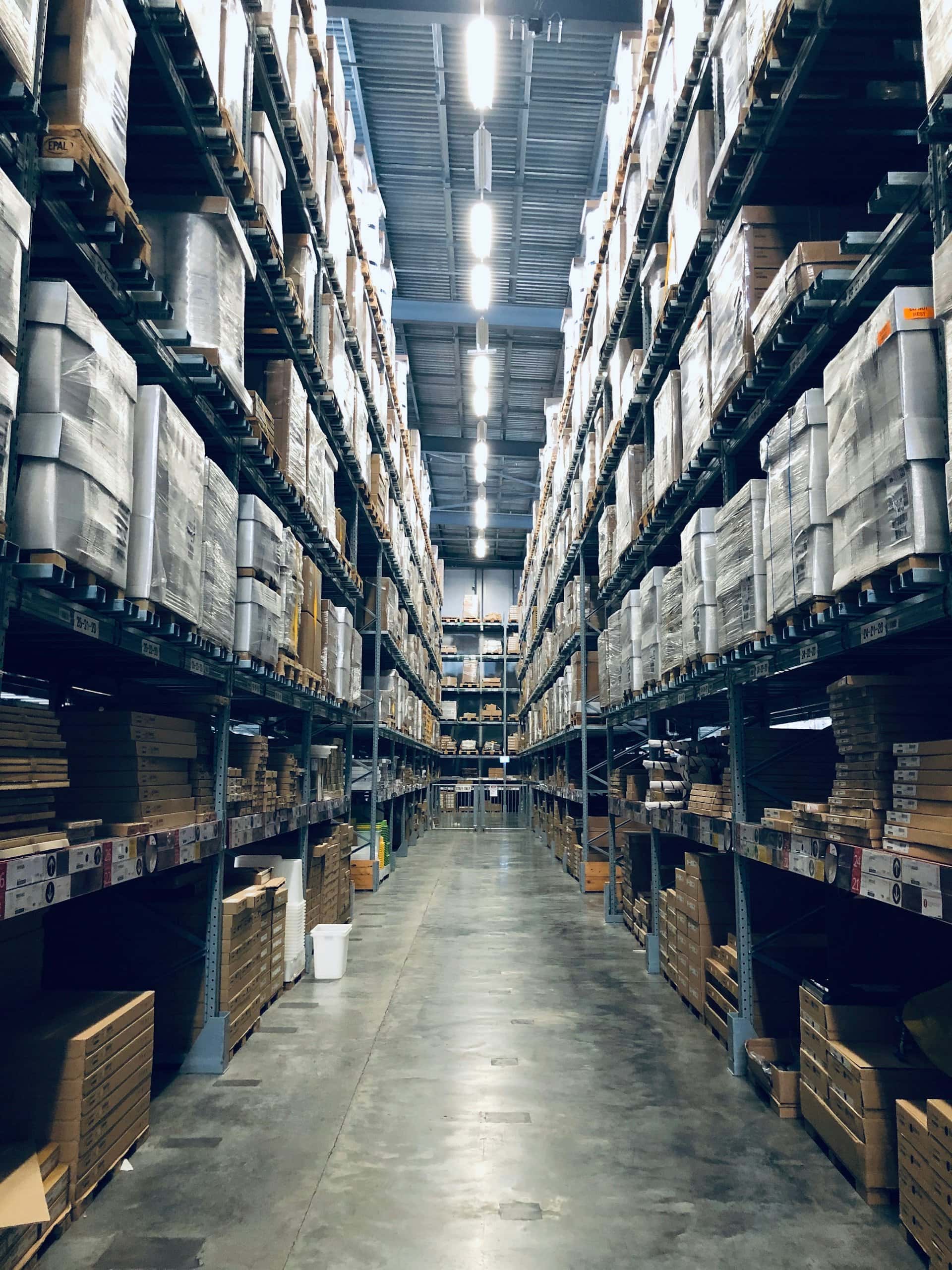 Warehouse aisle with packaged goods stored on high racks