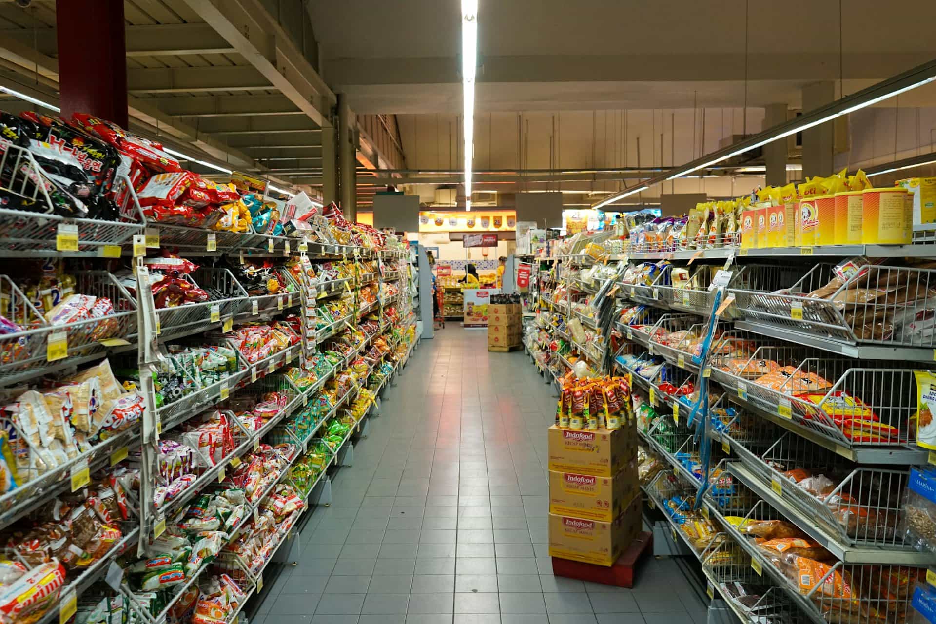 Supermarket aisle with packaged food products on shelves